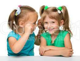 Two little girls are chatting