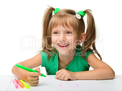 Cute little girl draws with markers