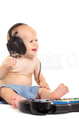 Little boy in headphones on the white