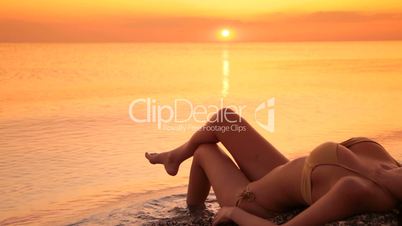 beautiful woman in  bikini on the beach at sunset