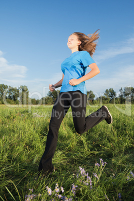 young  woman running on the grass