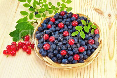 Blueberries with red currants on the board