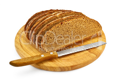 Rye bread on a round board with a knife