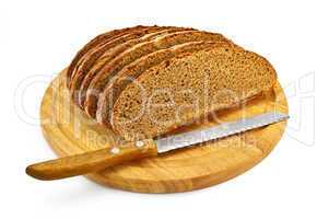 Rye bread on a round board with a knife