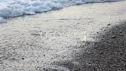 Children walking on the beach at sunset