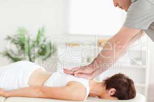 Masseur massaging female customer's back