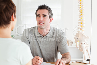 Doctor and patient sitting at a table talking