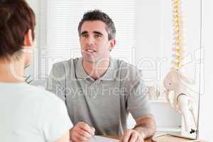 Doctor and patient sitting at a table talking