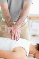A masseur massages a woman's back