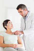 Male Doctor examining a female patient