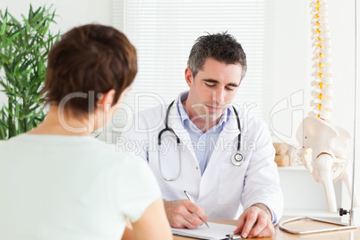 Male Doctor writing something down