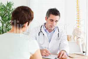 Male Doctor writing something down