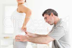 CHiropractor examining a woman's back