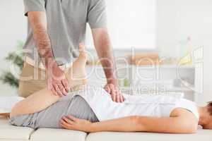 Chiropractor stretches woman's leg