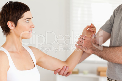 Chiropractor examining a woman's arm