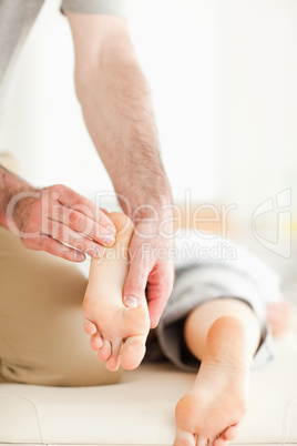 Man massaging a woman's feet