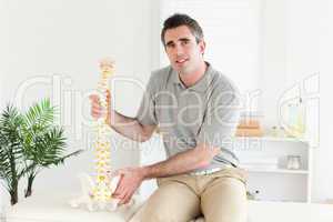 Chiropractor with the model of a spine