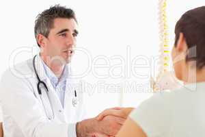 Male Doctor greeting a female patient