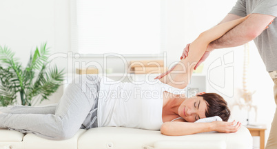 Chiropractor stretching woman's arm