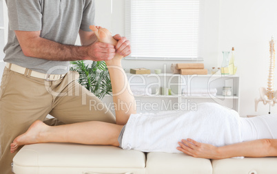Masseur massages customer's leg