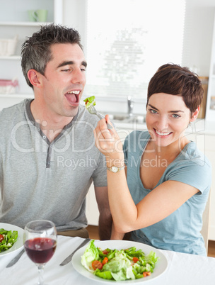 Cute Woman feeding her boyfriend