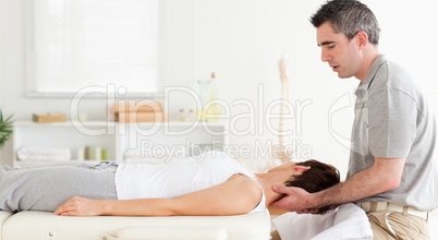 Masseur stretching customer's head