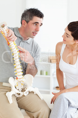 Chiropractor explaining the spine to his patient