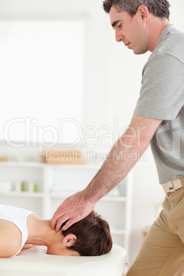 Masseur massaging female customer's neck