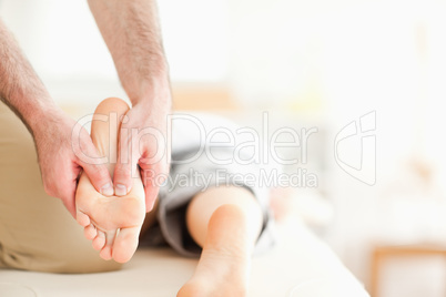 Male masseur massaging a woman's feet