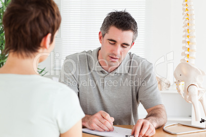 Doctor sitting at a table with a female patient