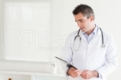 Smiling male Doctor looking at a chart