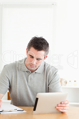 Doctor sitting at a table with a tablet and a chart