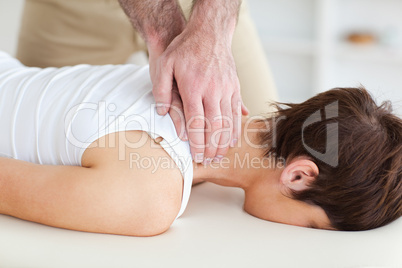 Masseur massaging customer's neck