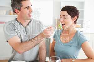 Man feeding his wife