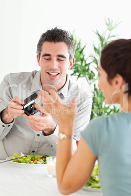 Man proposing to his charming girlfriend during dinner