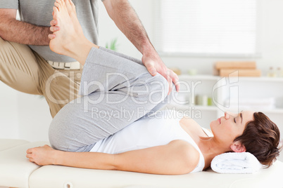 Chiropractor stretching a woman's legs