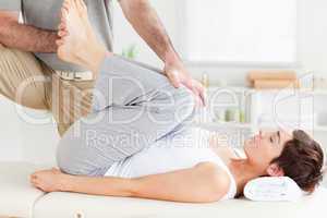 Chiropractor stretching a woman's legs