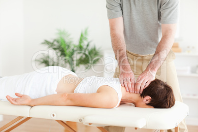 Guy massaging a brunette woman's neck