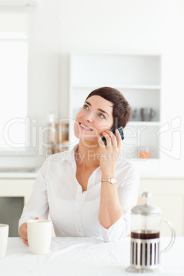 Woman with coffee on her mobile phone