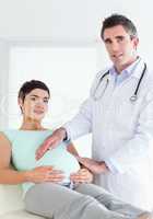 Portrait of a male doctor and a pregnant woman