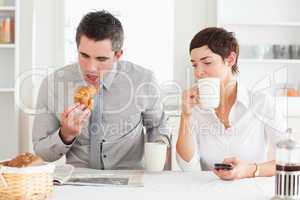 Cheerful couple having breakfast together