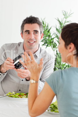 Man proposing to his cute girlfriend during dinner