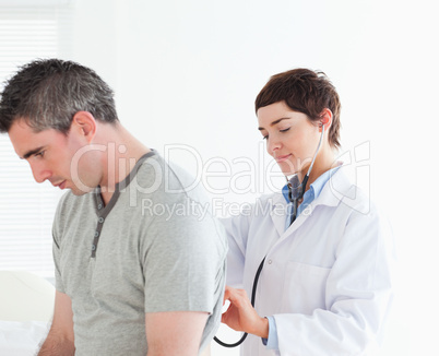 Doctor examining a male patient