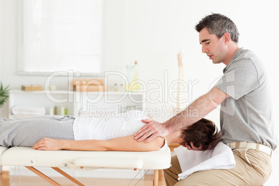 Masseur stretching a woman's head