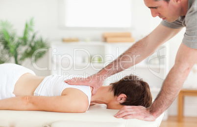 A masseur massaging a woman's back