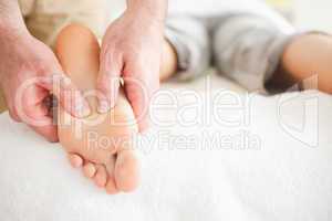 Male masseur massaging a woman's foot