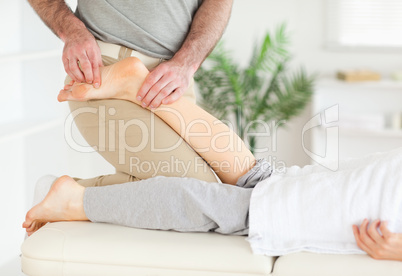 Masseur massaging woman's foot