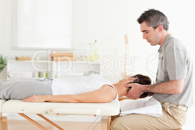 Masseur stretching woman's head