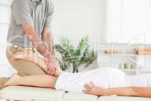 Masseur massages woman's leg