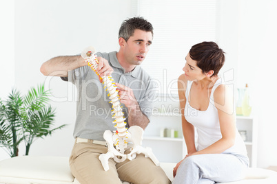 Brunette woman looking at a model-spine